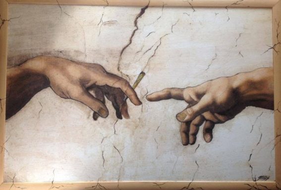 Airbrush artwork depicting two reaching hands inspired by classical art.
